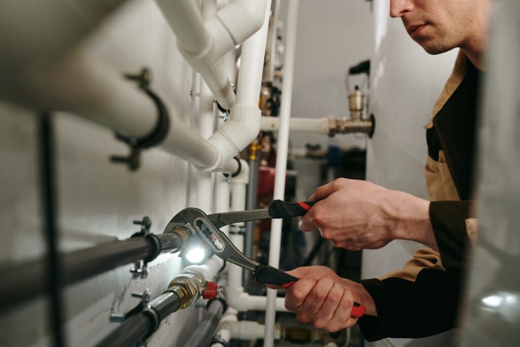 Plumbers maintaining commercial plumbing pipes in West Chester