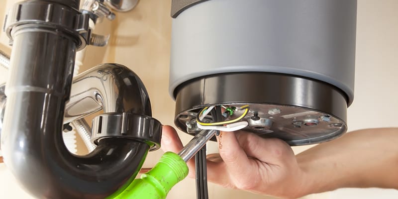 Technician repairing the heating element of a water heater in West Chester