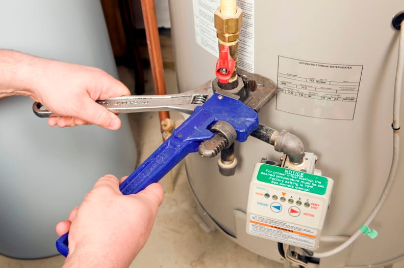 Plumber repairing a water heater valve in West Chester